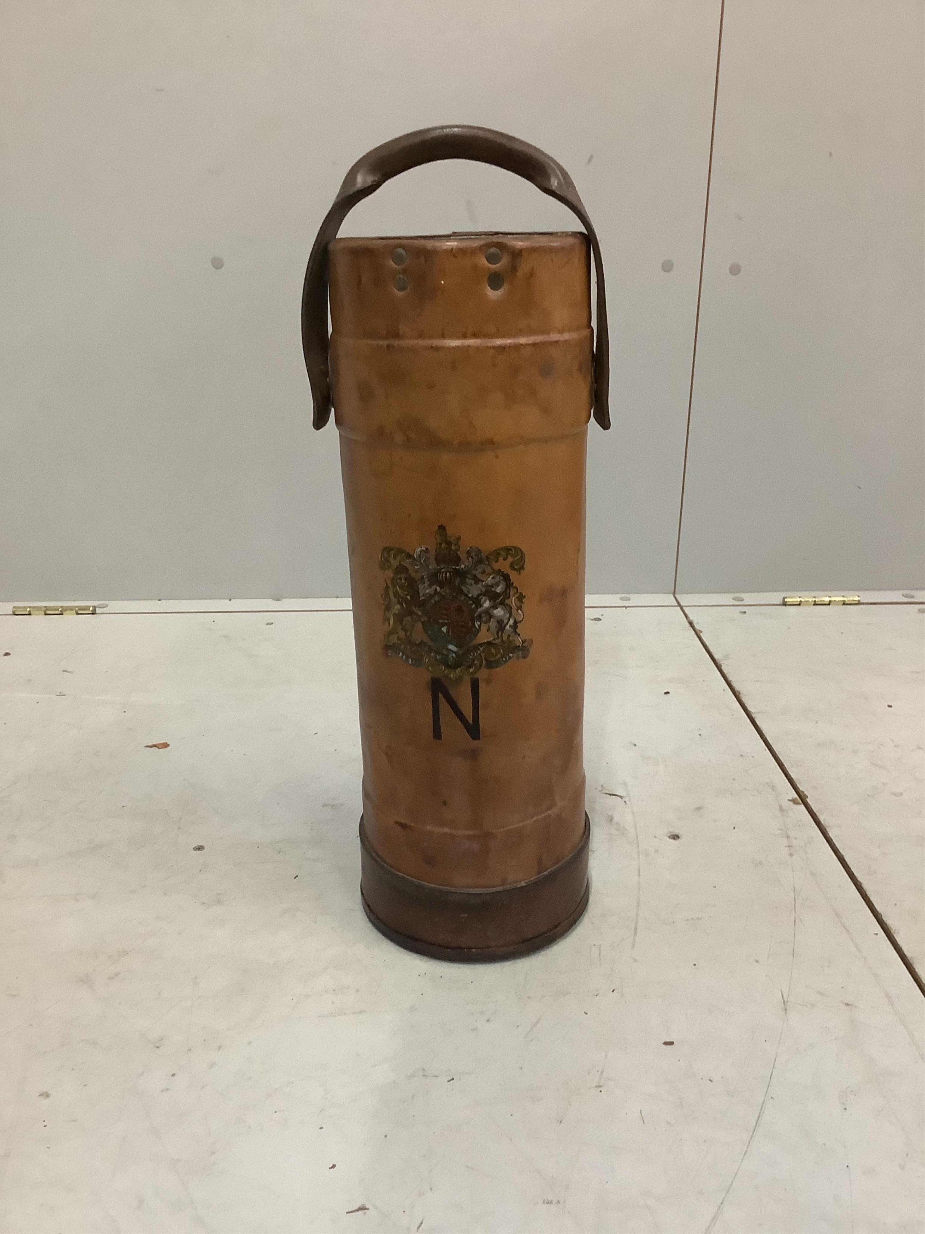 A tan leather shell carrier with armorial crest, height 60cm. Condition - fair